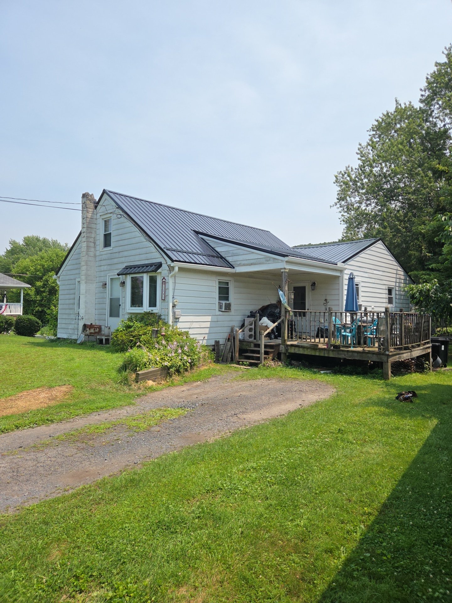 Danville PA home roof replacement using black tuff-rib metal with smooth panels
