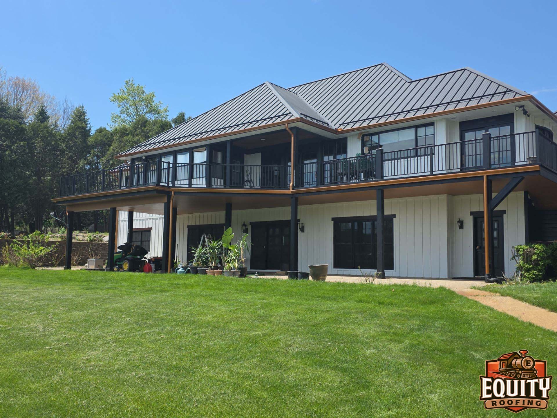 Home reno featuring standing seam metal roof James Hardie siding soffit fascia and copper gutters