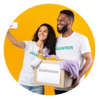 Two volunteers taking a selfie with a donation box