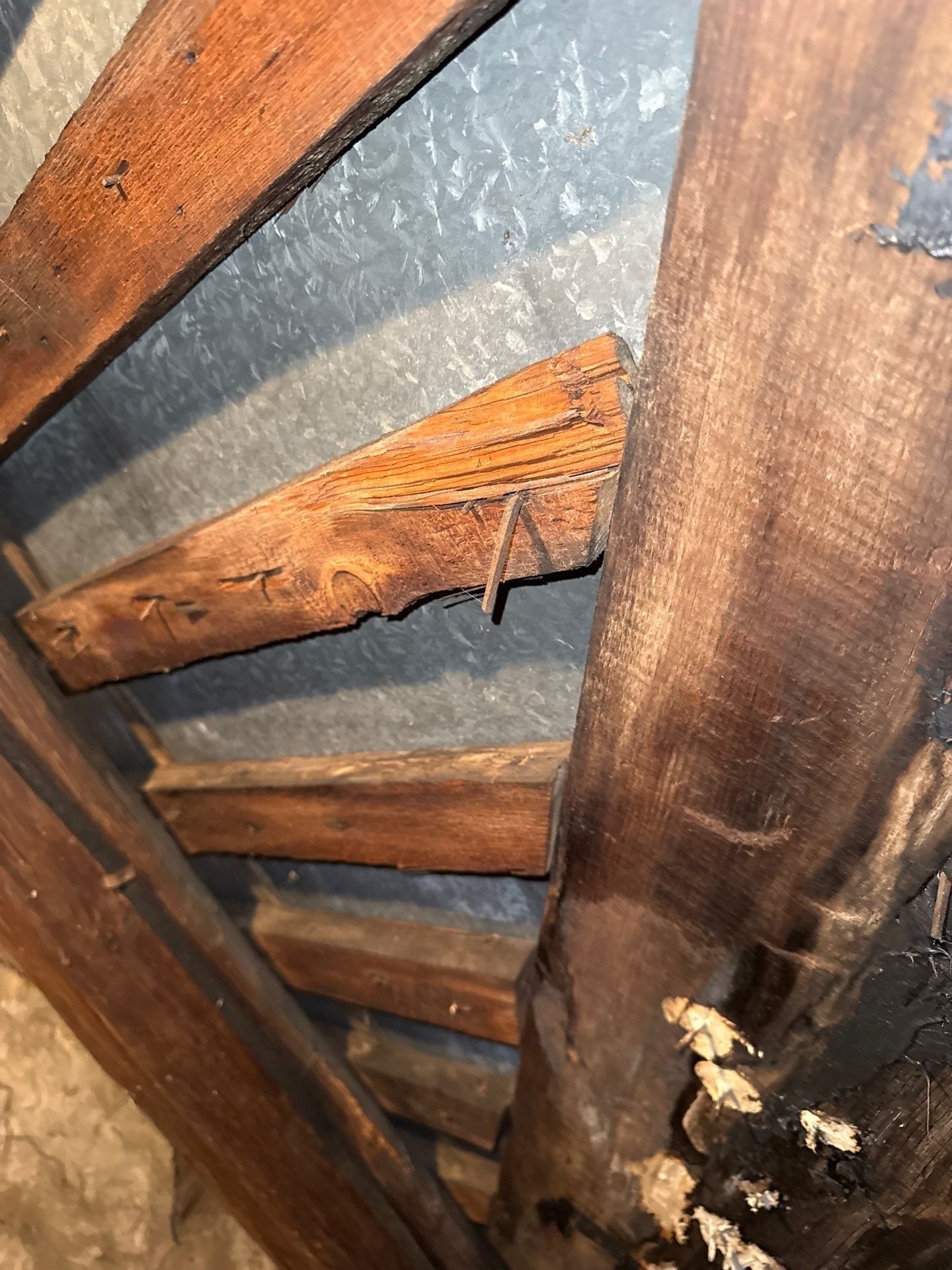 Water damage to wood sheathing beneath roof