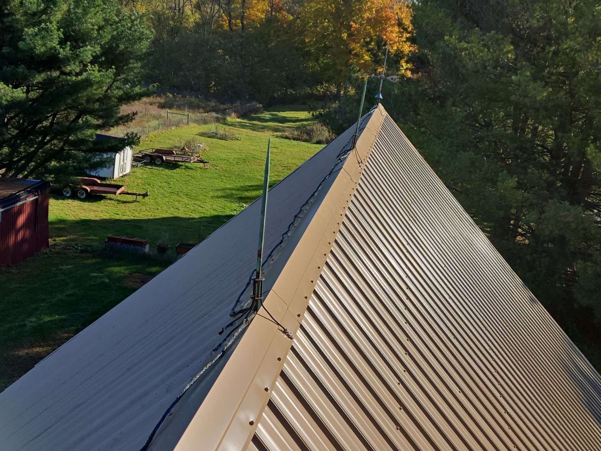 Exposed fastener metal roof with lightning rods