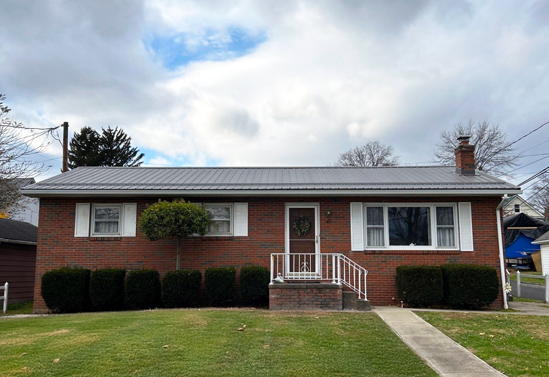 ranch style home with exposed fastener metal roof