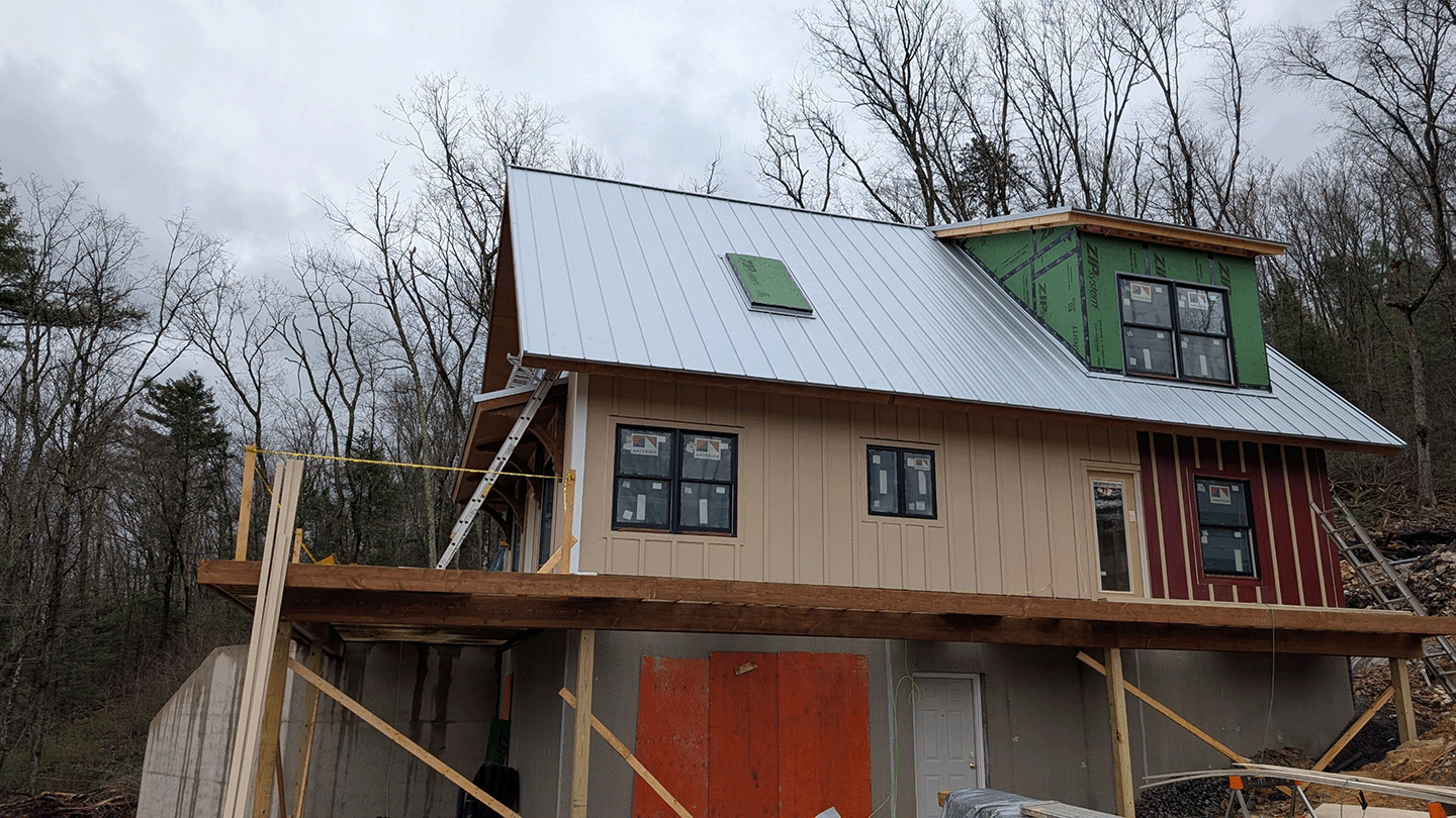 unpainted standing seam metal roof on new build